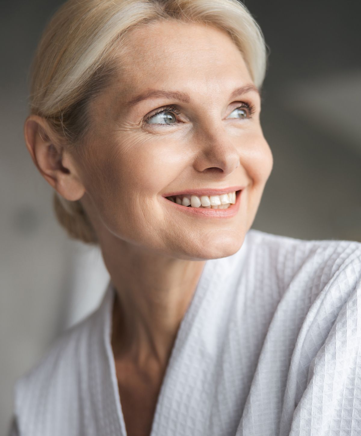 Woman with blonde hair wearing a hat.
