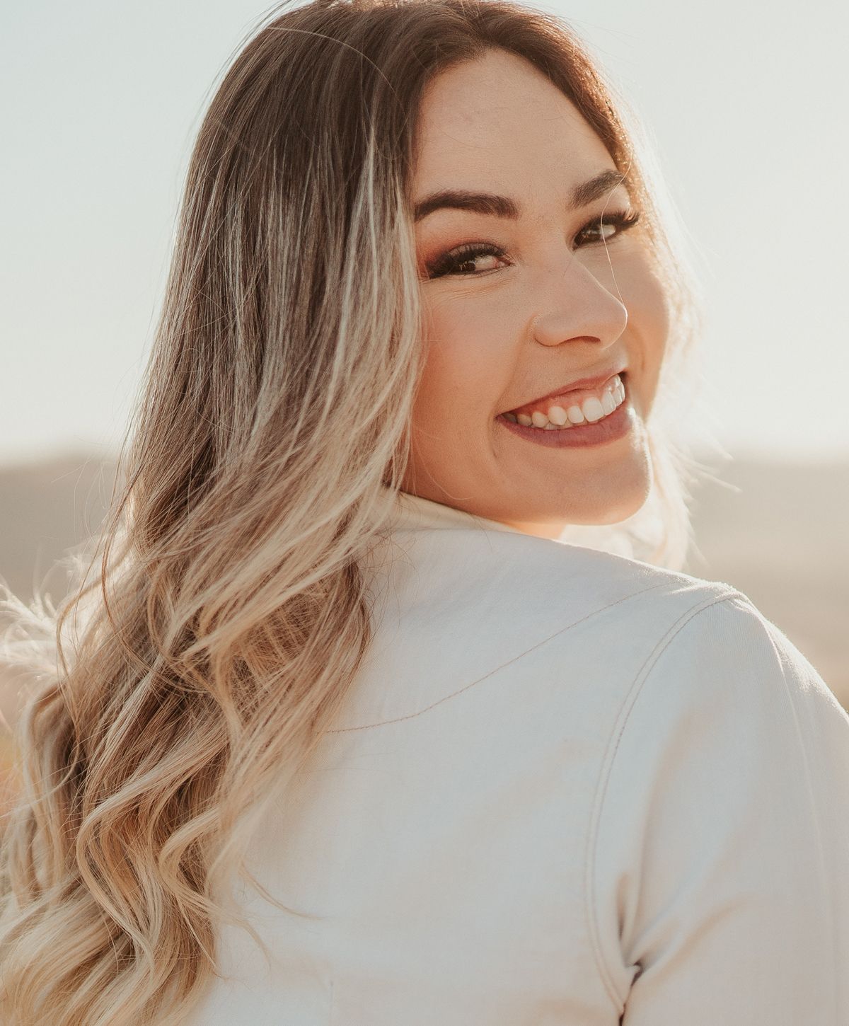Close-up portrait of a young woman smiling.