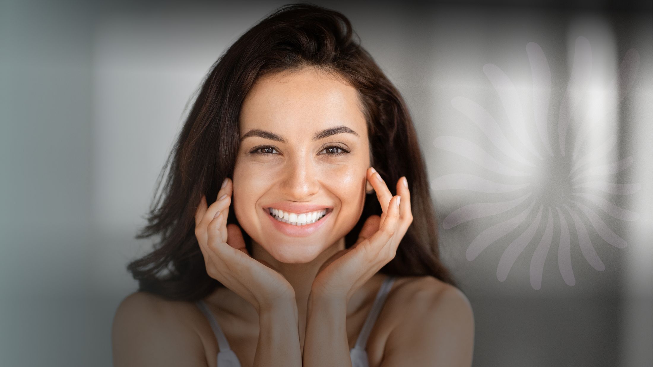 Smiling woman with hands on face.