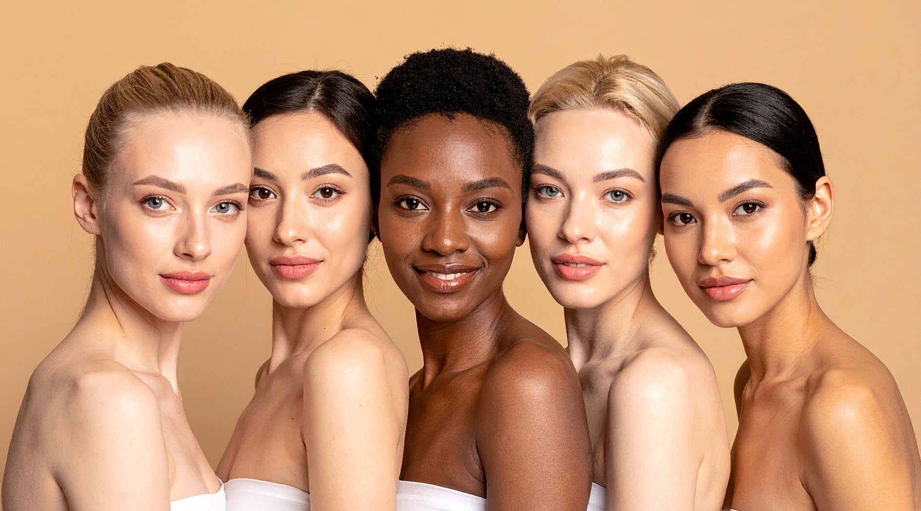 Diverse group of women smiling together.